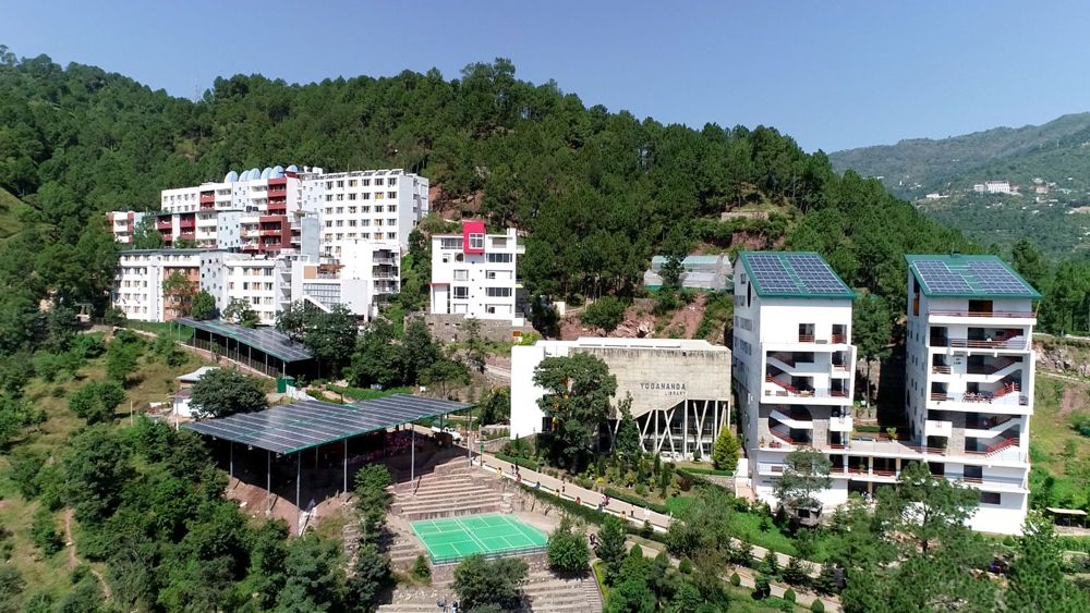 Shoolini University campus buildings among trees