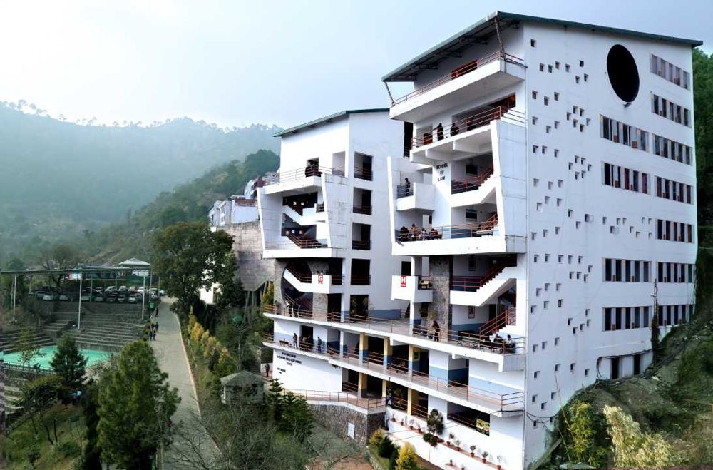 Modern white academic building on the Shoolini campus