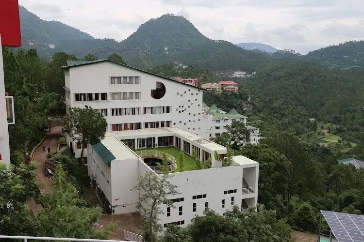 Shoolini campus building with hills behind